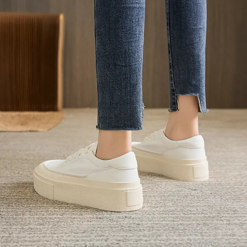 Women's black embossed cowhide leather platform sports shoes with white rubber sole and lace-up front.