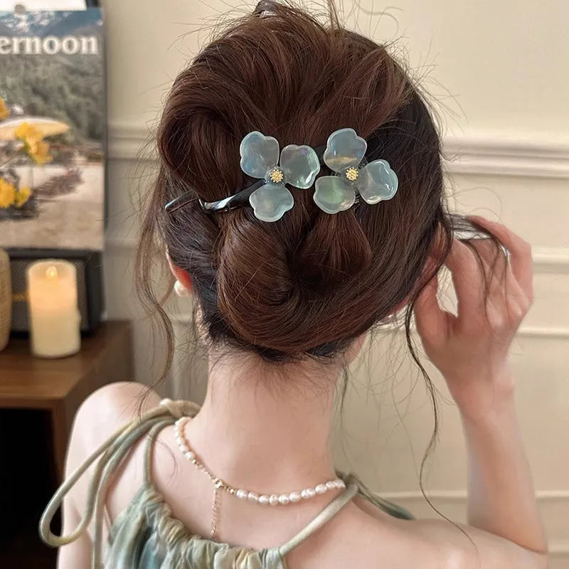 Retro flower hair bobby pin with coloured acrylic petals on a white background.