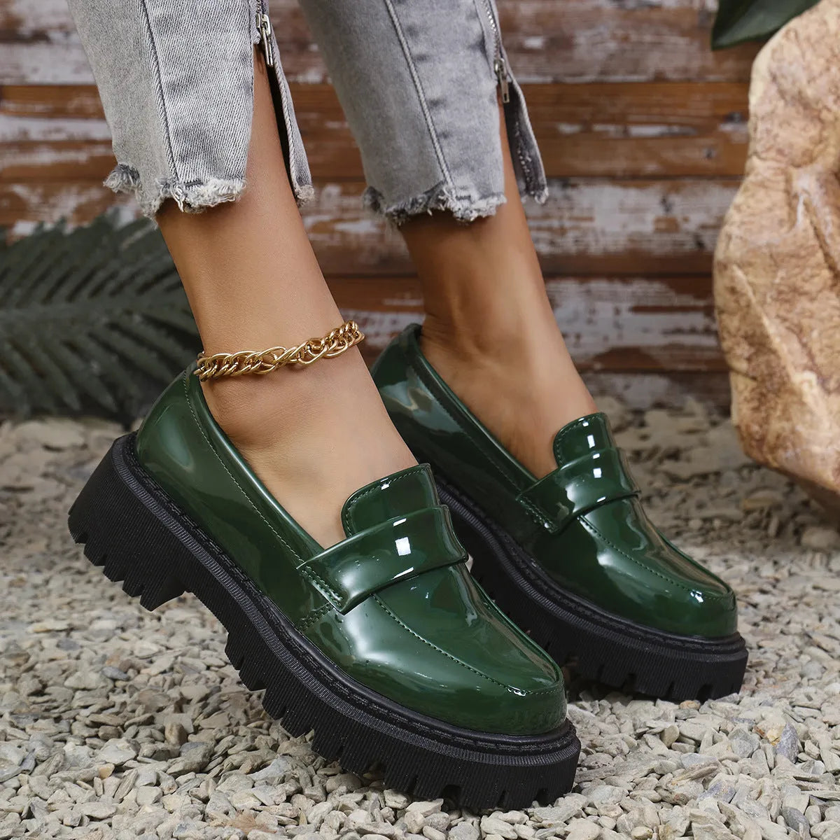 Plus size slip-on loafers with chunky heel in black, green, and wine red colours on a solid background