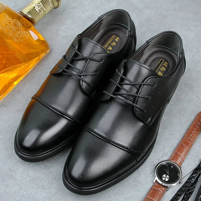 Men's black leather lace-up shoe with decorative stitching and a horse buckle on a rubber sole.