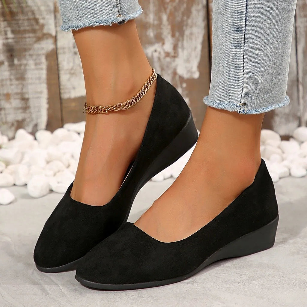 Women's plus size pointed toe wedge pumps with suede upper and low heel in black, blue, gray, khaki, or light brown.
