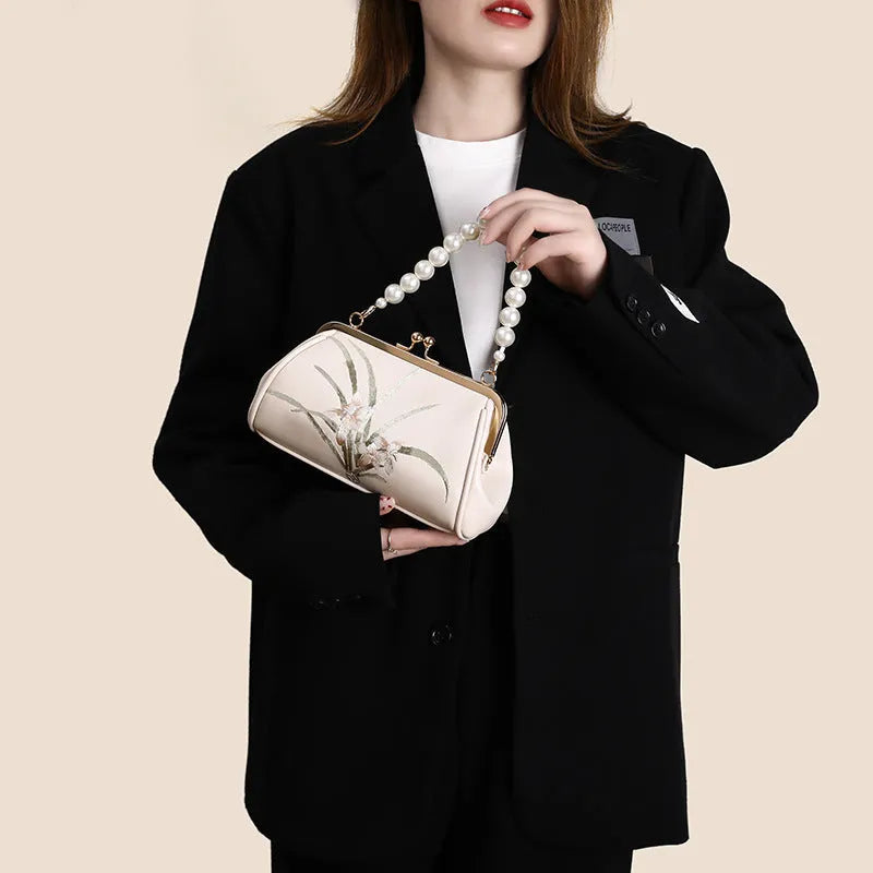 Beige women's embroidered shoulder bag with shell shape design in soft PU material