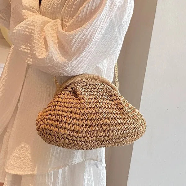 Women's khaki paper straw shoulder bag with a chain strap and shell shape.