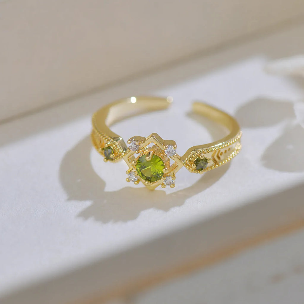 Geometric copper open mouth ring with purple zircon stones in round settings