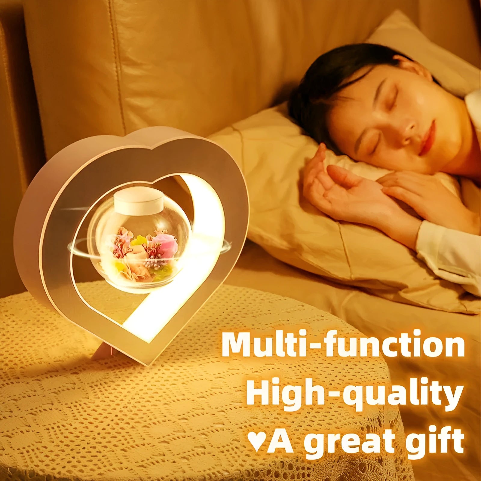 Pink magnetic levitation heart LED night light rotating above a triangular base on a desk.