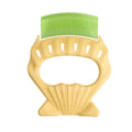 Shell-shaped pet grooming brush in green, orange, or purple with bent wire bristles and anti-slip handle