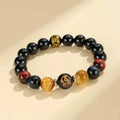 Handmade black agate beaded bracelet with tiger eye stones and Buddhist deity zodiac charms