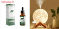 Spherical white lunar humidifier and night light with USB charging port and soft LED glow.