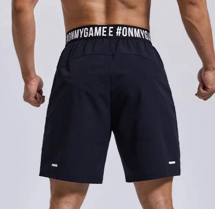 Men's loose black sports shorts with cropped design and elastic waist for workouts