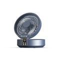 White portable USB rechargeable fan with remote control on a desk, showing its folding head and night light.