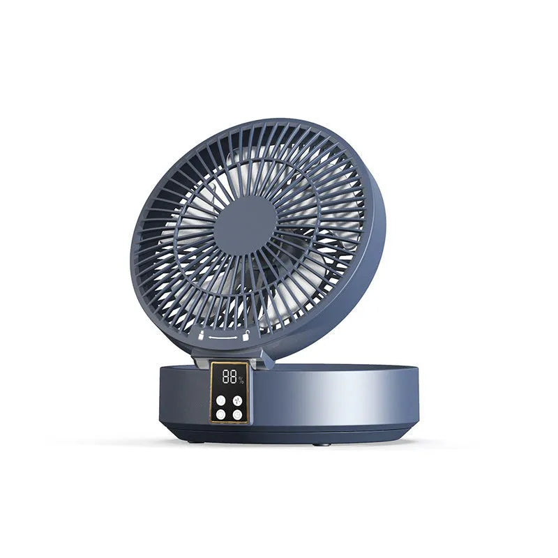White portable USB rechargeable fan with remote control on a desk, showing its folding head and night light.