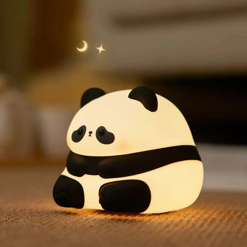 Panda-shaped night light with soft silicone surface, measuring 150x130x80mm, showing warm white glow