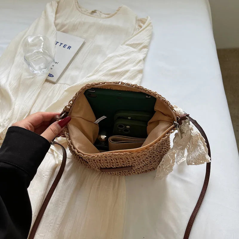 Women's woven straw messenger bag with hollowed design in khaki colour showing vertical square shape and single shoulder strap