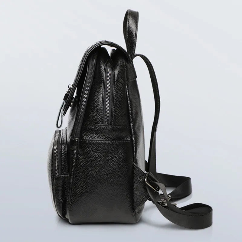 Solid colour genuine leather women's backpack showing blue exterior with multiple compartments and internal organisation
