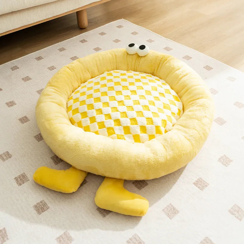 Blue plush kennel-style dog bed with raised sides, shown on a wooden floor.