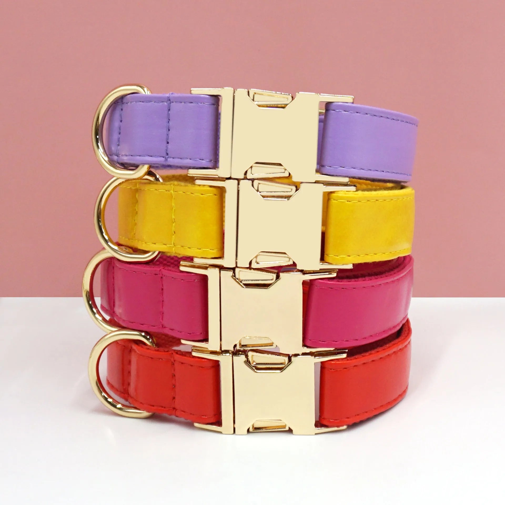 Leather dog collar with velvet texture section in colour block design, shown on a buckle.