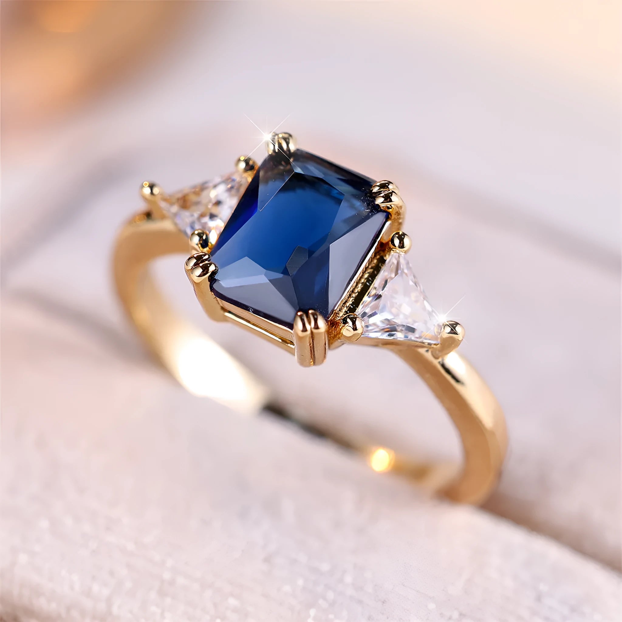 Gold sapphire blue rectangular copper ring for women showing geometric shape and metallic finish