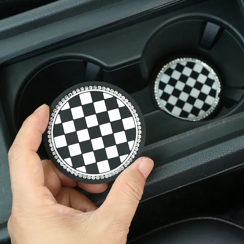 Black and white checkerboard plastic car cup mat placed in a vehicle door slot.