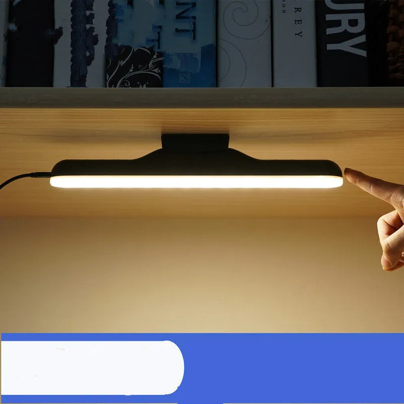 White plastic LED desk lamp with touch controls and adjustable brightness settings on wooden desk