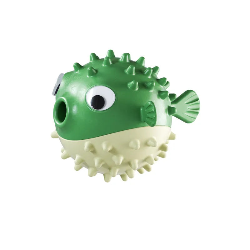 Green fish-shaped interactive dog toy with treat dispensing feature and dental cleaning particles