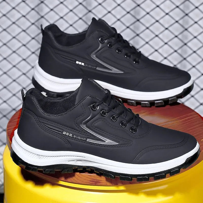 Waterproof casual sports shoes in black-grey colour with flat plastic sole and low-top design