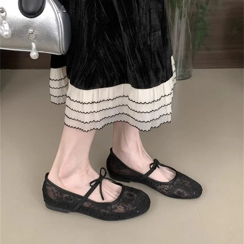 Women's flat lace mesh Mary Jane shoes in pink with a mid heel and buckle strap.