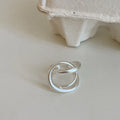 Geometric open ring with interlaced design and matte finish in gold or silver colour with real gold plating