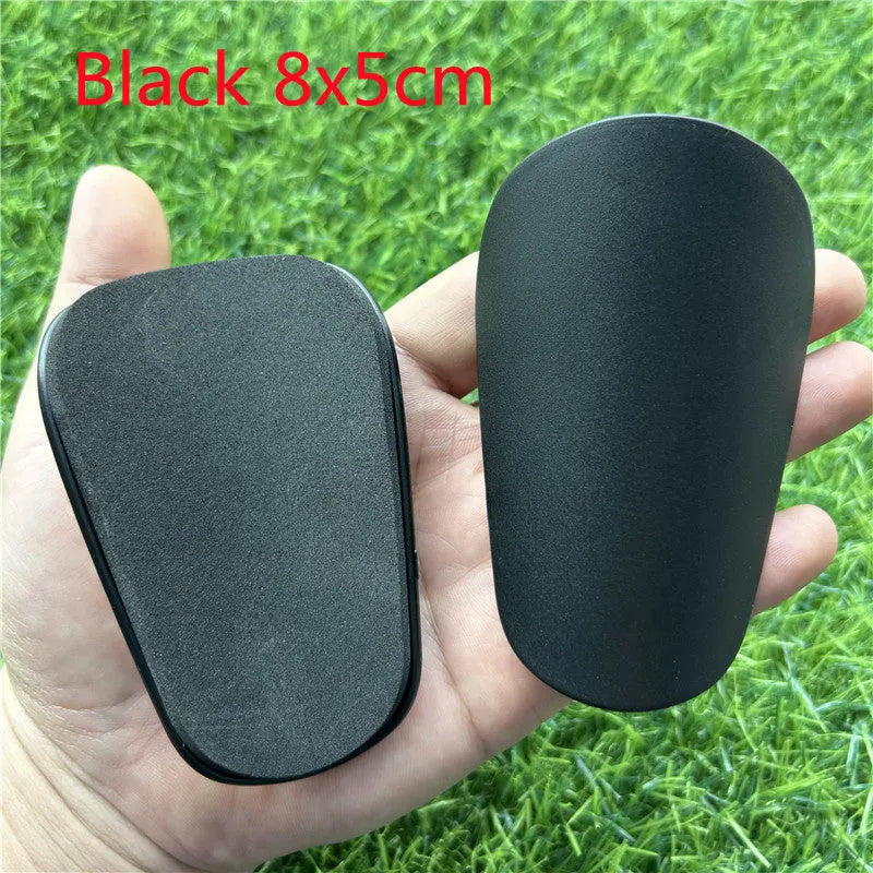 Extra small mini football shin guards in black and white measuring 8x5cm