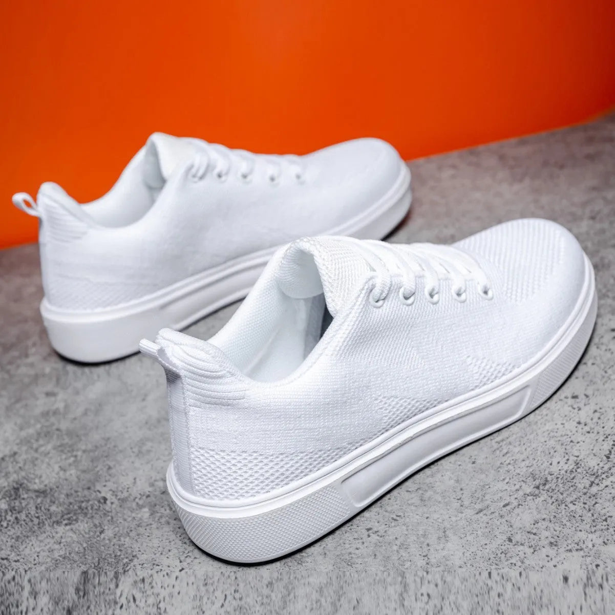 Flat heel casual board shoes with mesh upper and EVA sole in black or white colours