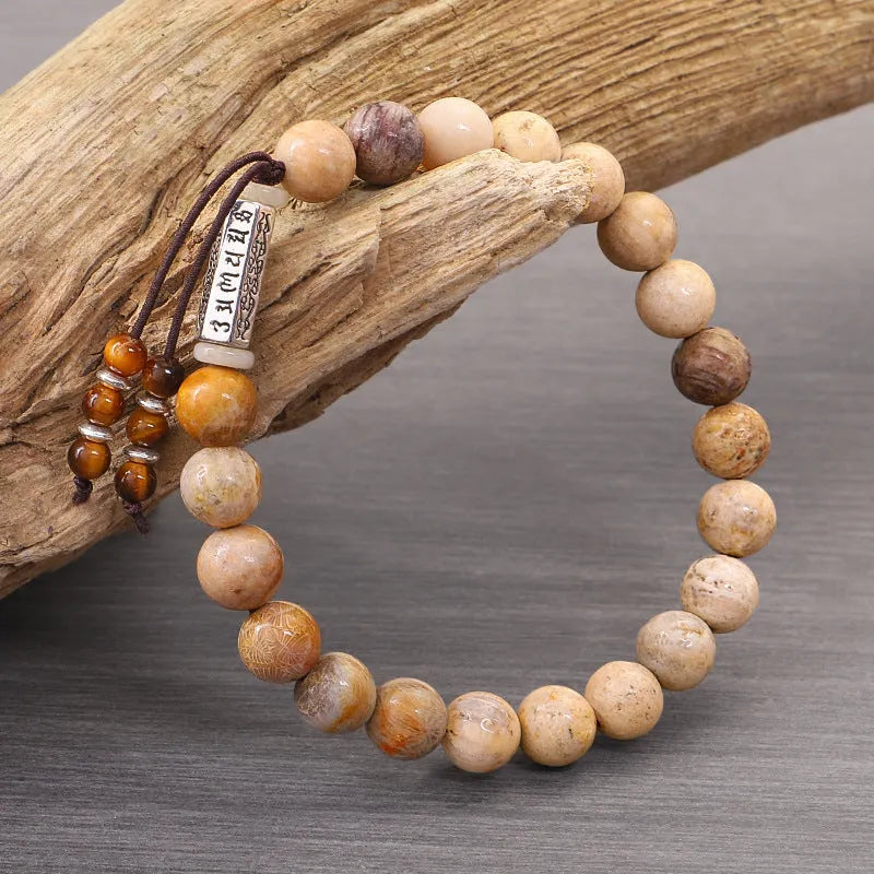 Handmade natural stone bead bracelet in a wood tone colour on a white background.