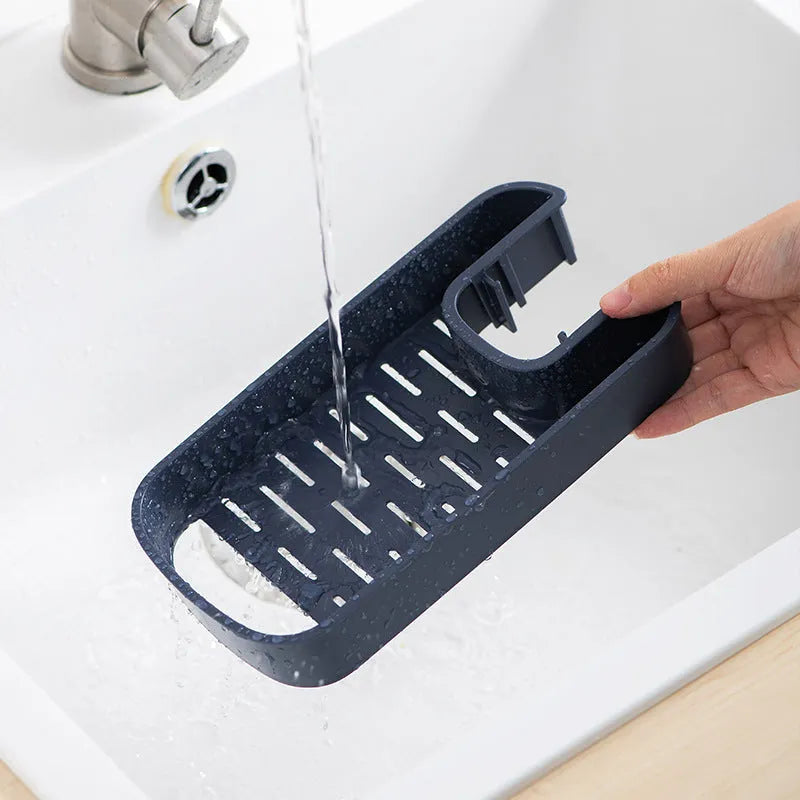 Blue adjustable sink shelf with sponge and brush storage mounted on kitchen faucet