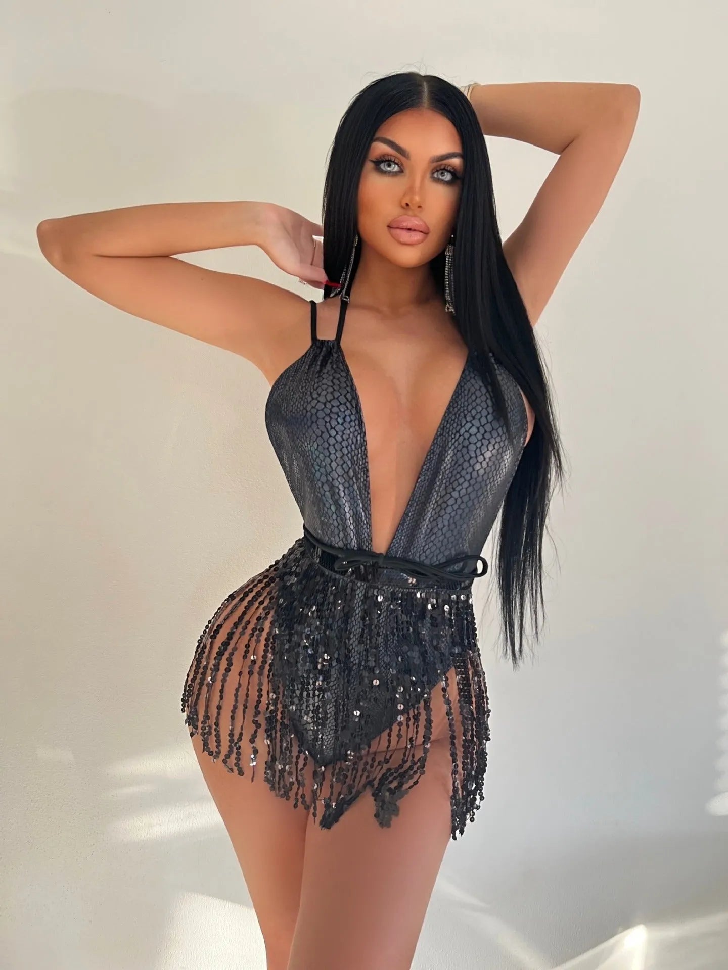 Backless one-piece swimsuit in gold colour, showing spandex construction and sleek fit.