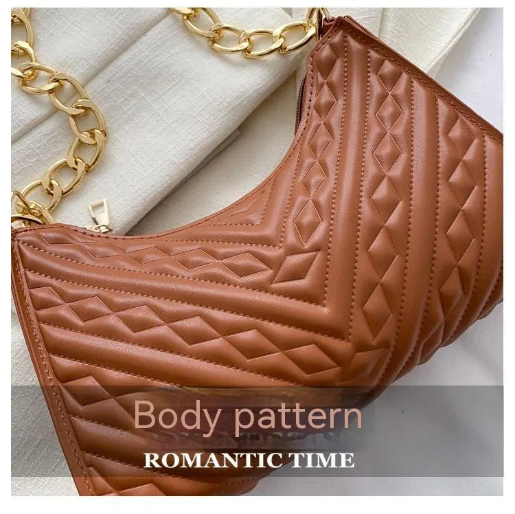 Brown pleated chain baguette shoulder bag with adjustable strap and soft carry handle showing three-dimensional pocket design