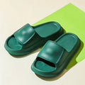 EVA flip-flop slippers with thick sole in multiple colours on a bathroom floor