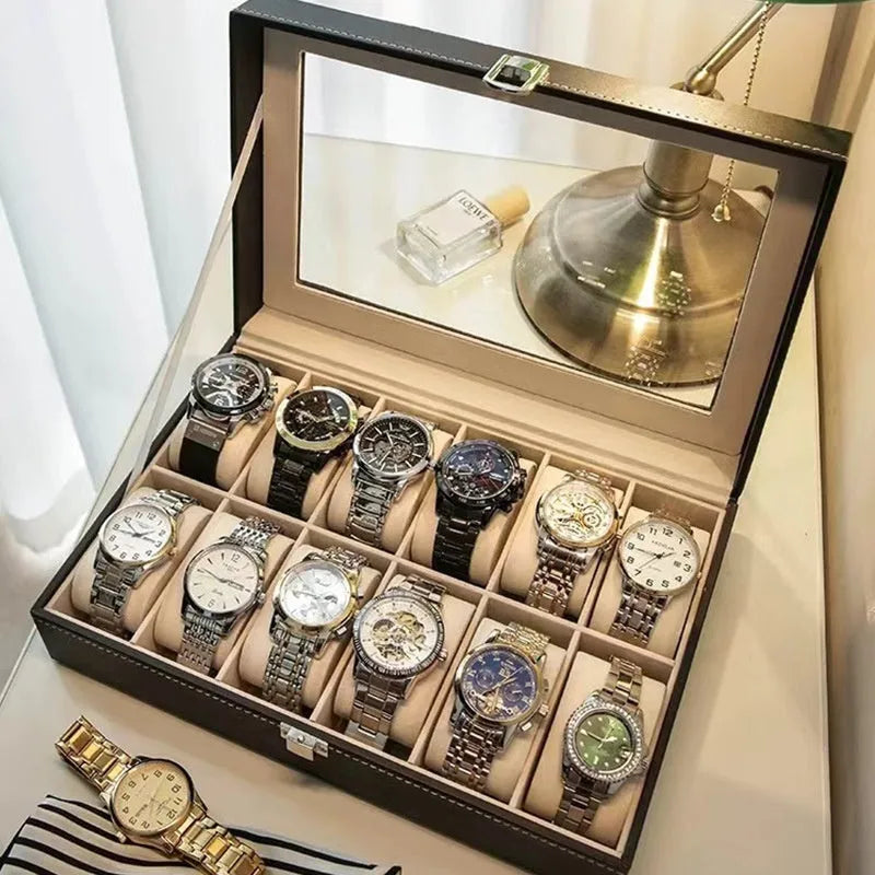 Grey leather watch storage box with see-through lid showing watch compartments