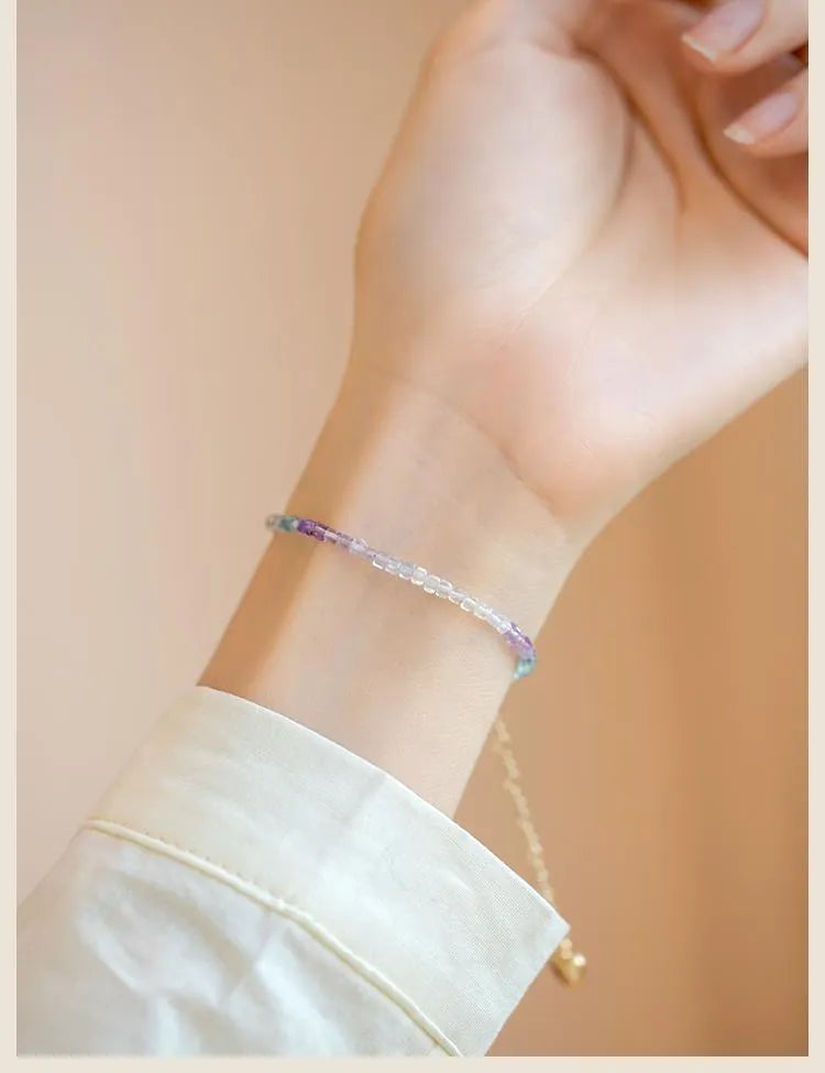 Handmade women's rainbow fluorite bracelet with copper geometric settings