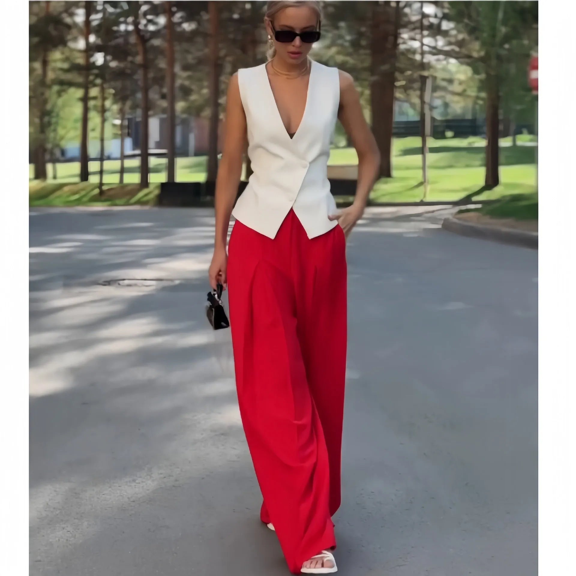 Beige women's sleeveless deep V-neck top and high-waist wide-leg trousers two-piece set on a hanger.