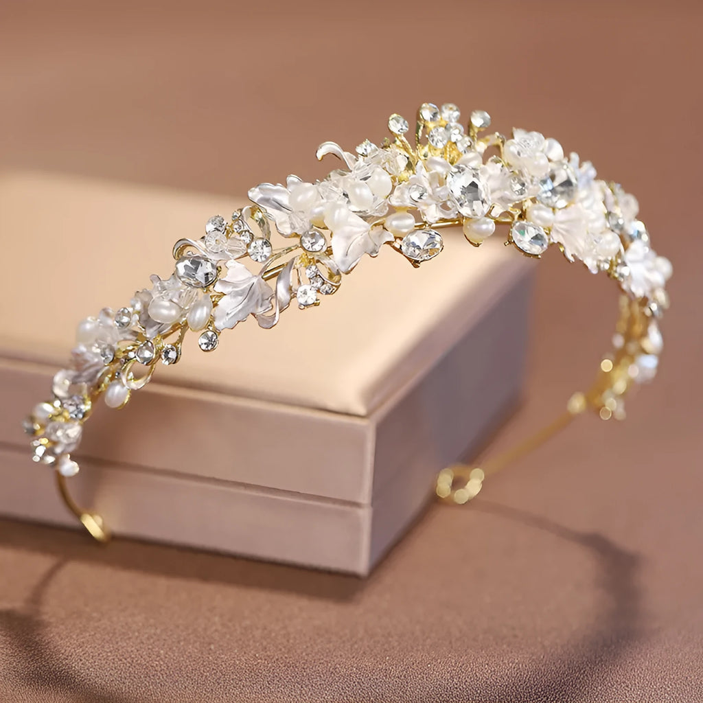 Gold and silver alloy pearl crown headdress hair accessory for women on a white background.