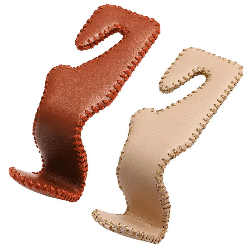 Gold-coloured stainless steel car seat back hook for organising bags on vehicle headrests.