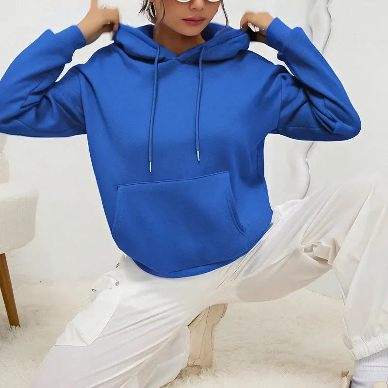 Women's loose grey sweatshirt with long sleeves and a front drawstring pocket, shown in a relaxed fit.