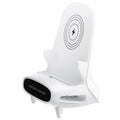 White mini chair shaped wireless charging stand holding smartphone on desk