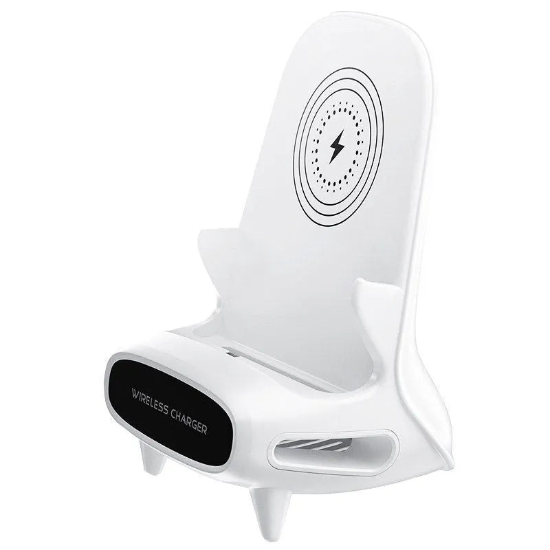 White mini chair shaped wireless charging stand holding smartphone on desk