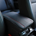 Black PU leather car armrest box mat with red cord trim, size 32x19 cm