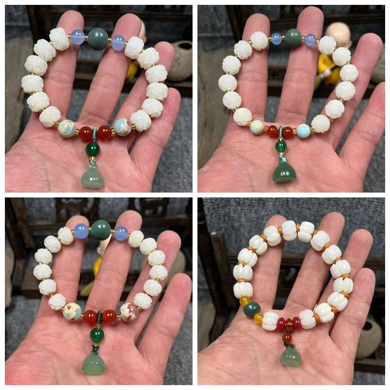 Hand-carved Bodhi root bracelet with White Jade beads, lotus carvings, and a cat's paw pendant.