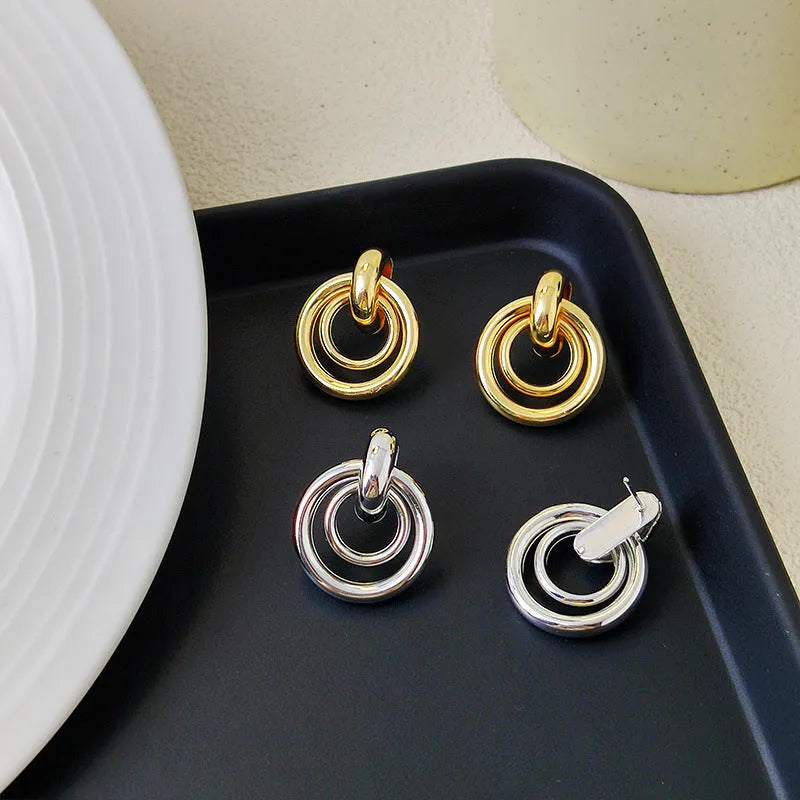 Geometric round ring earrings in gold or silver colour with irregular exotic styling