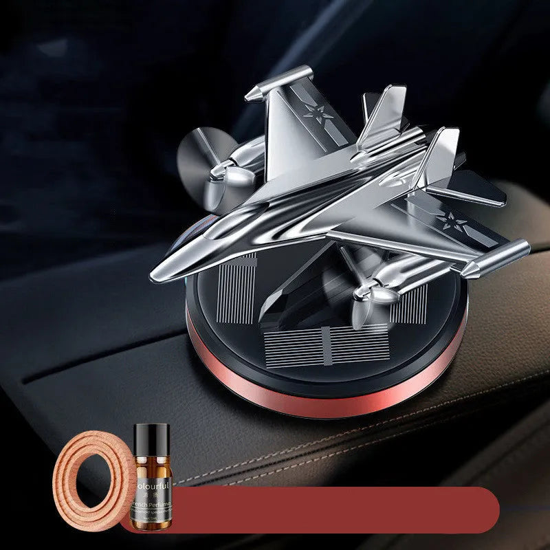 Solar-powered rotating fighter jet perfume ornament in silver, gold, blue, or red with aluminium alloy construction
