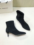 Women's black pointed toe ankle boots with a high stiletto heel on a microfiber upper.