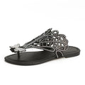 Women's black slip-on sandals with flip-toe design, rhinestone detail on the upper, and a flat rubber sole.