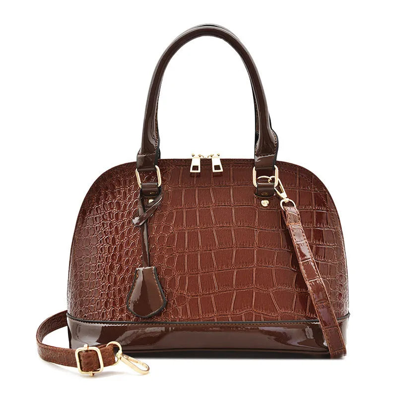 Large shiny crossbody shoulder bag with shell shape design showing 22x30x15cm dimensions