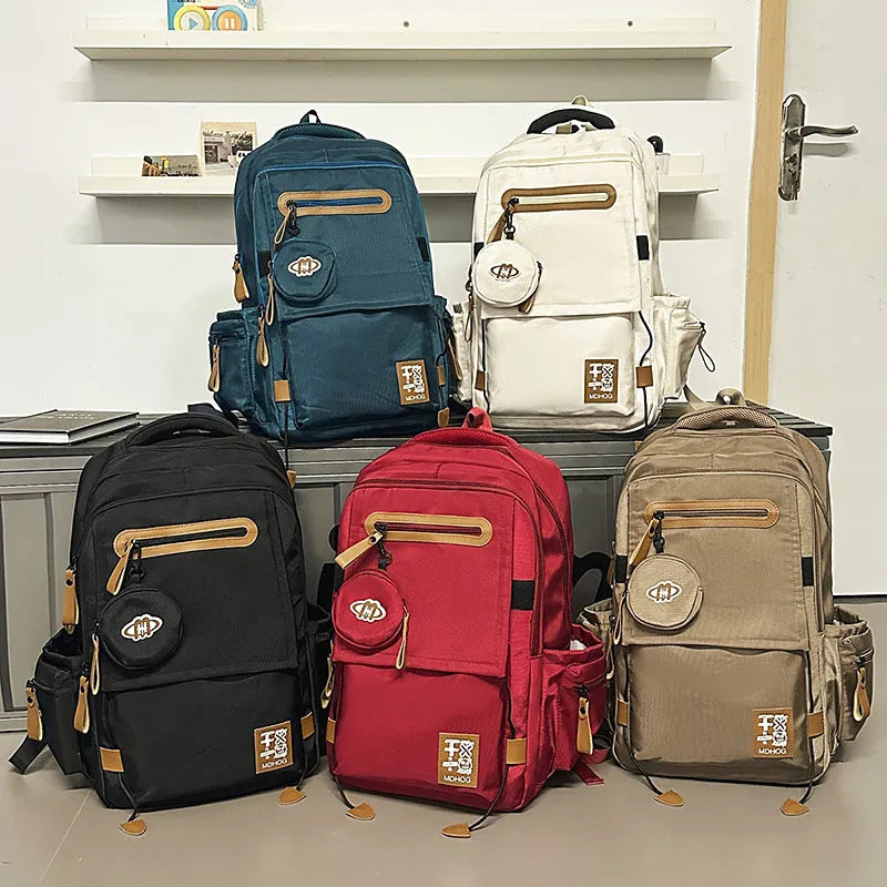 Large waterproof travel backpack in black with contrast colour stitching showing 20-35 litre capacity